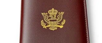 A passport cover made of high-quality leather with a minimalist design, featuring subtle embossing of a national emblem in gold, smooth texture, elegant and professional appearance, soft natural lighting highlighting the material